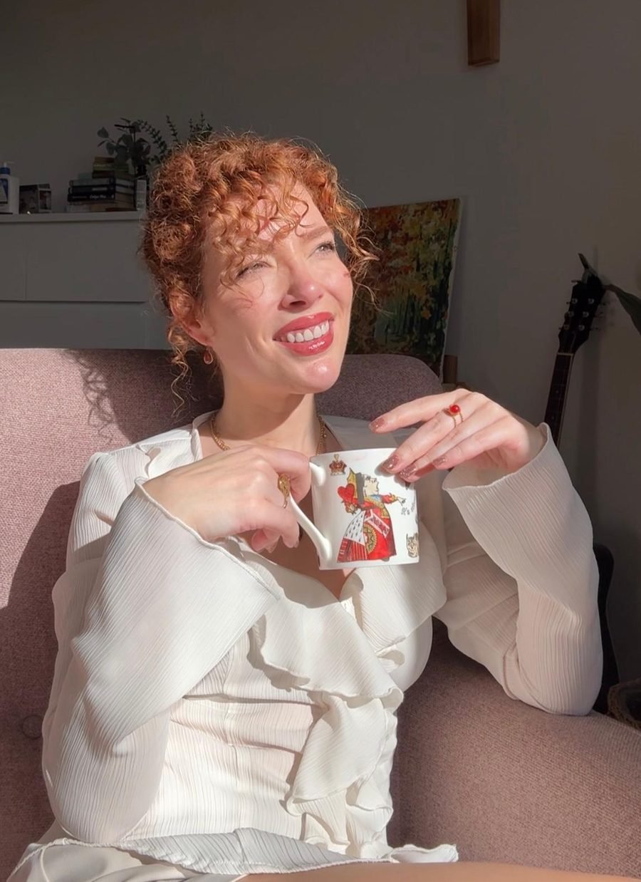 Mercè sonriendo con una taza en las manos, al sol